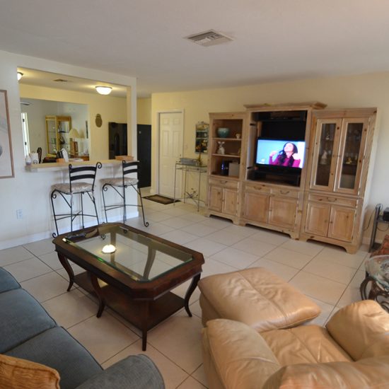 Endless Summer Living Room and Breakfast Bar | CSE Properties, Naples, FL